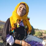 An old Berber woman proudly presents her morning harvest